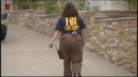 An FBI agent is seen during the bust of an international gambling ring on Wednesday, June 19, 2013.