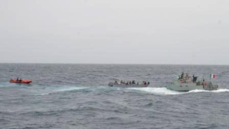 As a U.S. Coast Guard cutter stands by, the Mexican navy approaches a panga boat with three suspected drug smugglers and an estimated 250 bales of marijuana aboard south of San Diego Tuesday, June 18, 2013.