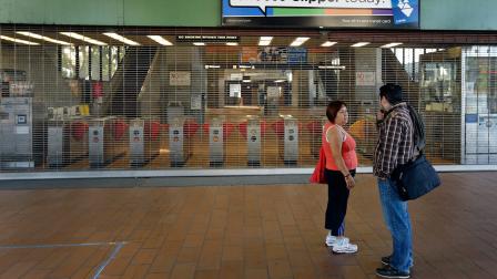 A couple discuss a different way to travel upon learning that the Fruitvale BART station is closed due to a strike Monday, July 1, 2013, in Oakland, Calif.