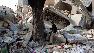 A man sits among the rubble of collapsed buildings in Port-au-Prince, Jan. 14, 2010