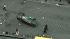 A car is tossed on its roof and a man is...