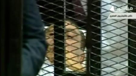 An ailing, 83-year-old Hosni Mubarak, lying on a hospital bed inside a metal defendants cage, denied charges of corruption and complicity in the killing of protesters at the start of his historic trial on Wednesday, Aug. 3, 2011.