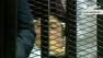 An ailing, 83-year-old Hosni Mubarak, lying on a hospital bed inside a metal defendants cage, denied charges of corruption and complicity in the killing of protesters at the start of his historic trial on Wednesday, Aug. 3, 2011.