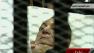 An ailing, 83-year-old Hosni Mubarak, is seen on a hospital bed inside a metal defendants cage at his historic trial on Monday, Aug. 15, 2011.