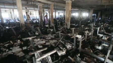 Garment workers look through burned remains inside the Smart Export Garment Ltd. factory where a fire claimed the lives of seven female workers in Dhaka, Bangladesh, Saturday, Jan. 26, 2013.