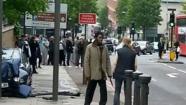 A photo shows a woman confronting two accused terrorists who had just killed a British soldier.