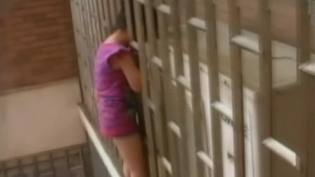 A 5-year-old girl is seen with her head caught between the 24th-floor window bars of an apartment building in China on Saturday, July 20, 2013.