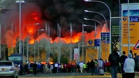 A crowd gathers as a fire engulfs Kenyas airport on Wednesday, Aug. 7, 2013.