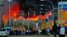 A crowd gathers as a fire engulfs Kenyas airport on Wednesday, Aug. 7, 2013.