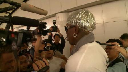 Retired NBA star Dennis Rodman, center, talks to journalists upon arriving at the Beijing capital airport in Beijing, China, Saturday, Sept. 7, 2013.