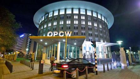 A car arrives at the headquarters of the Organization for the Prohibition of Chemical Weapons, OPCW, Sept. 27, 2013 in The Hague, Netherlands.