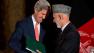 U.S. Secretary of State John Kerry, left, leans in toward Afghan President Hamid Karzai as they say goodbye at the end of a news conference at the Presidential Palace in Kabul, Afghanistan Saturday, Oct. 12, 2013.