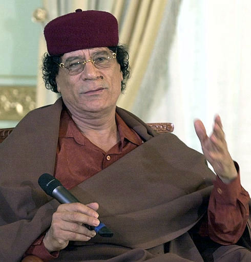 Libyan leader Moammar Gadhafi gestures during a...