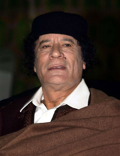 Libyan leader Moammar Gadhafi looks on during...