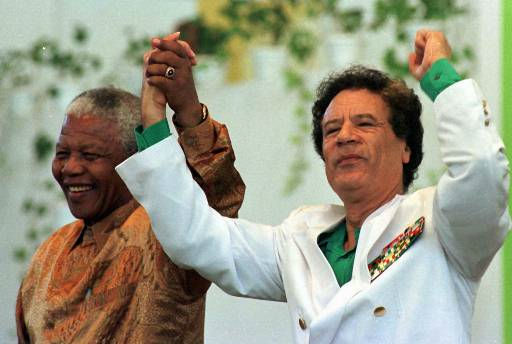 Libyan President Moammar Gadhafi, right, and...