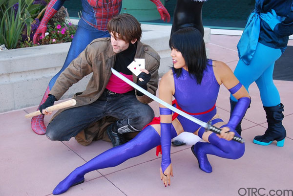 Fans dressed as Gambit and Psylocke pose outside...
