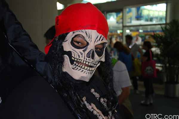 A fan with a skull mask is seen at Comic-Con in...