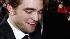 Robert Pattinson signs autographs as he arrives at The Twilight Saga: New Moon premiere in Westwood, Calif. Monday, Nov. 16, 2009.
