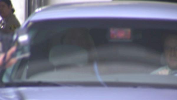 Lindsay Lohan sits in the back of the car that escorted her to the Century Regional Detention Facility in Lynwood where she is set to serve a 90-day sentence for violating the terms of her probation.