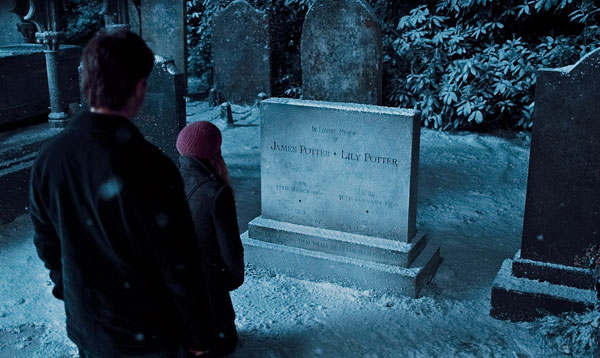 Harry Potter (Daniel Radcliffe) looks at his parents' tombstone in a scene from 'Harry Potter and the Deathly Hallows - Part 1.'