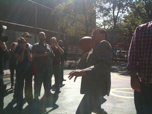 Pee-wee Herman horses around on a basketball...
