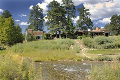 Val Kilmer's New Mexico Ranch. It contains a main log house and a guest house with seven bedrooms and 11 bathrooms in total. The property is as of December 2010 on sale for $18.5 million - down from $33 million in 2009.