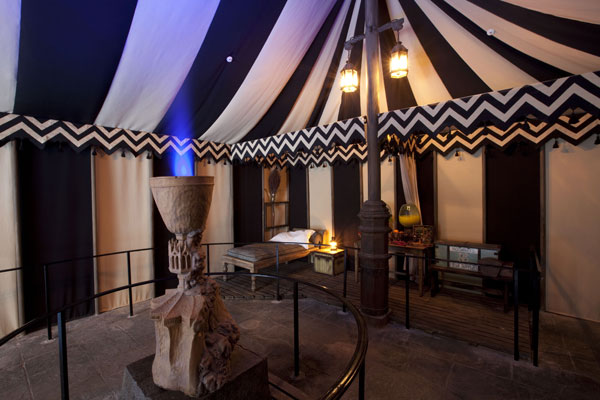 Guests step through a gothic archway as they...