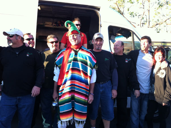 Garth the Elf puts on a poncho at the...