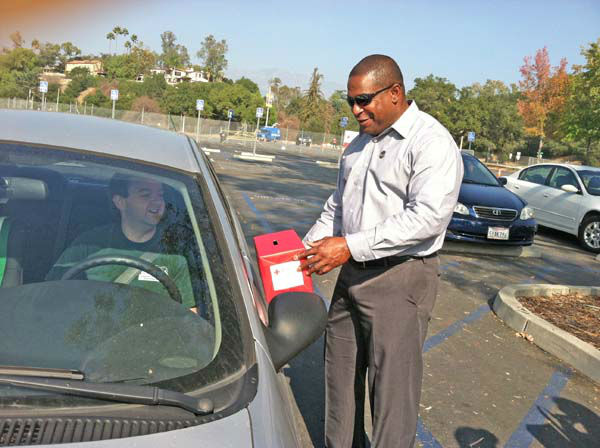 ABC7 Eyewitness News reporter Leo Stallworth collects a donation from a viewer at our Sandy relief drive at the Rose Bowl in Pasadena on Friday, Nov. 2, 2012.