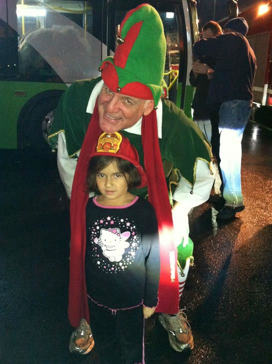 Garth the Elf poses with a future firefighter at...
