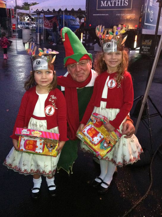 Garth the Elf poses with two young princesses at...