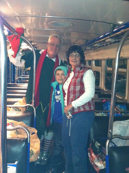Garth the Elf poses with toy donors at the Stuff-A-Bus toy drive at Mathis Brothers Furniture in Ontario on Friday, Nov. 30, 2012.