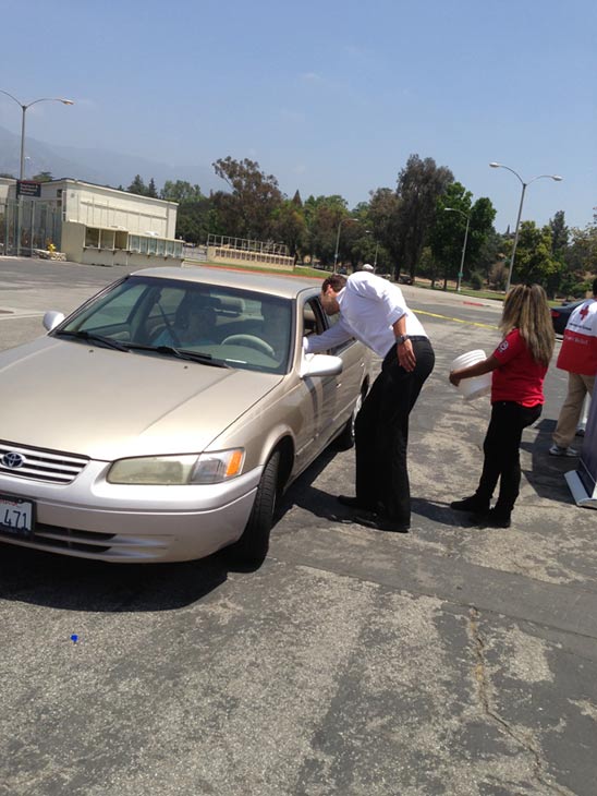ABC7 Reporter Elex Michaelson greets two donors...