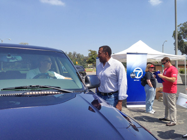 ABC7 Anchor Marc Brown greets a donor at a...