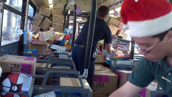 Residents help Garth the Elf Stuff-A-Bus in Anaheim, December 18, 2009