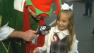 A little girl speaks with Garth the Elf at the Stuff-A-Bus toy drive at Los Cerritos Center on Friday, Dec. 7, 2012.