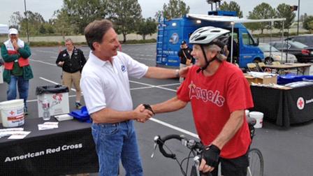 ABC7 Reporter Ric Romero greets a donor who came out to the Honda Center in Anaheim to help the Red Cross raise funds for the victims of the Oklahoma tornado on Wednesday, May 22, 2013.