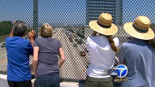Curious spectators watch traffic flowing on Interstate 405 after it reopened Sunday, July 17, 2011.