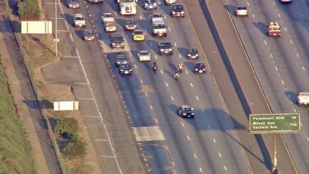 A police cruiser is seen reopenng lanes on the 60 East Freeway following a complete lane closure Monday, July 9, 2012.
