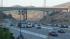 Commuters drive under the Mulholland Drive...