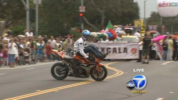 Performer Aaron Colton, sponsored by Red Bull, showcases his motorcycle skills during the 65th annual Mexican Independence Day Parade in East Los Angeles on Saturday, Sept. 10, 2011.