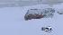 Driver attempts to dig car out of snow