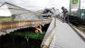 A worker cleans up a pile of debris from a collapsed metal building, Tuesday, Sept. 7, 2010 in Raymondville, Texas, after tropical storm Hermine swept through the area.