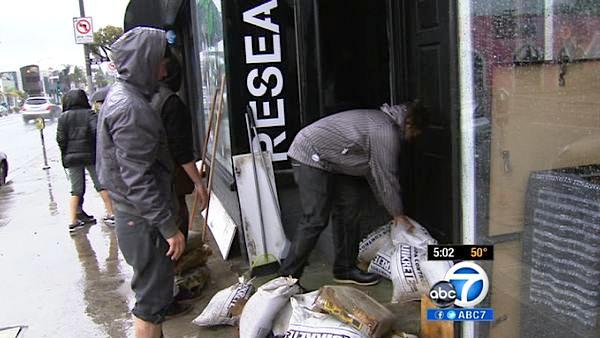 Sand bags are placed at the front of a business on Melrose Avenue in Hollywood to prevent overflow from a powerful storm that passed over Southern California on Sunday March, 25, 2012.