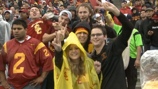 Football fans take in the USC-UCLA game at the Rose Bowl in Pasadena on a rainy Saturday, Nov. 17, 2012. The last time it rained on the annual crosstown rivalry game was 1961.