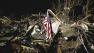 A flag flies in the debris of a mobile home after a tornado struck a mobile home park near Dale, Okla., Sunday, May 19, 2013.