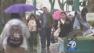 People are seen on a rainy day in Orange County on Wednesday, Oct. 9, 2013.