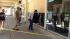 People outside a shop assess the damage caused...