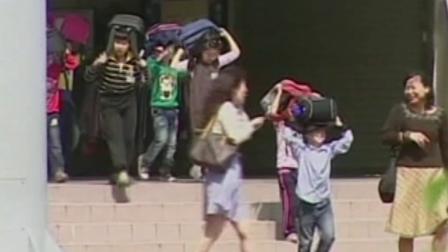 Children are seen leaving a building following an earthquake that struck central Taiwan on Wednesday, March 27, 2013.