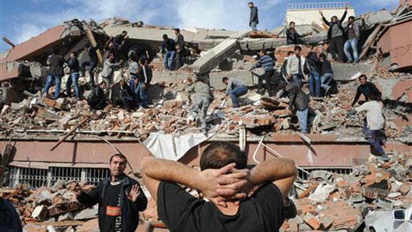 People try to save people trapped  under debris in Tabanli village near the city of Van after a powerful earthquake struck eastern Turkey Sunday Oct. 23, 2011, collapsing some buildings and causing a number of deaths, an official said.